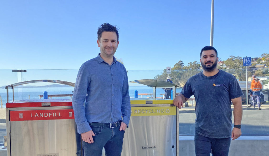 Photo of the Mayor of Kingborough Cr Dean Winter at new public recycling bins at Kingston Beach, with Youssef Assi, local business owner