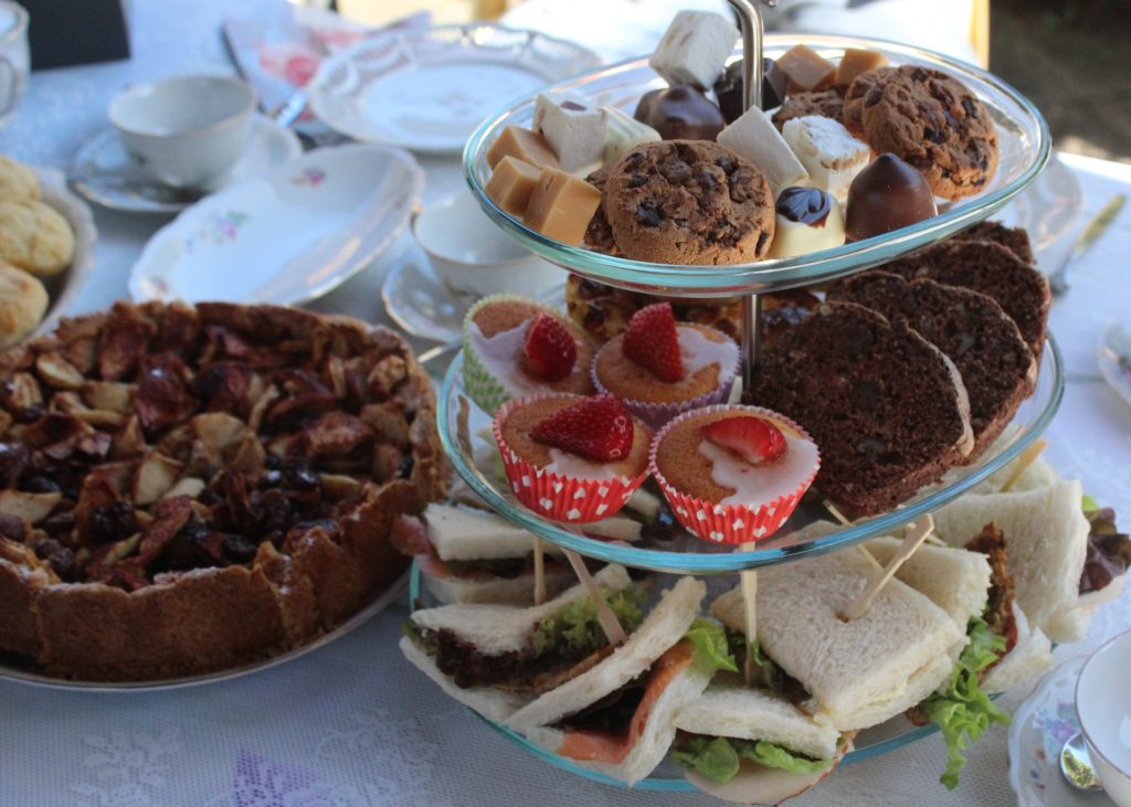 Photo of afternoon tea plates with sandwiches and cakes