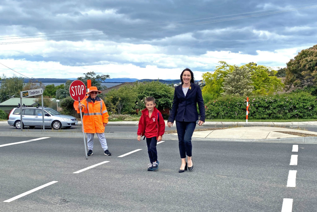 Photo of Cr Westwood and son Cooper crossing the road after school